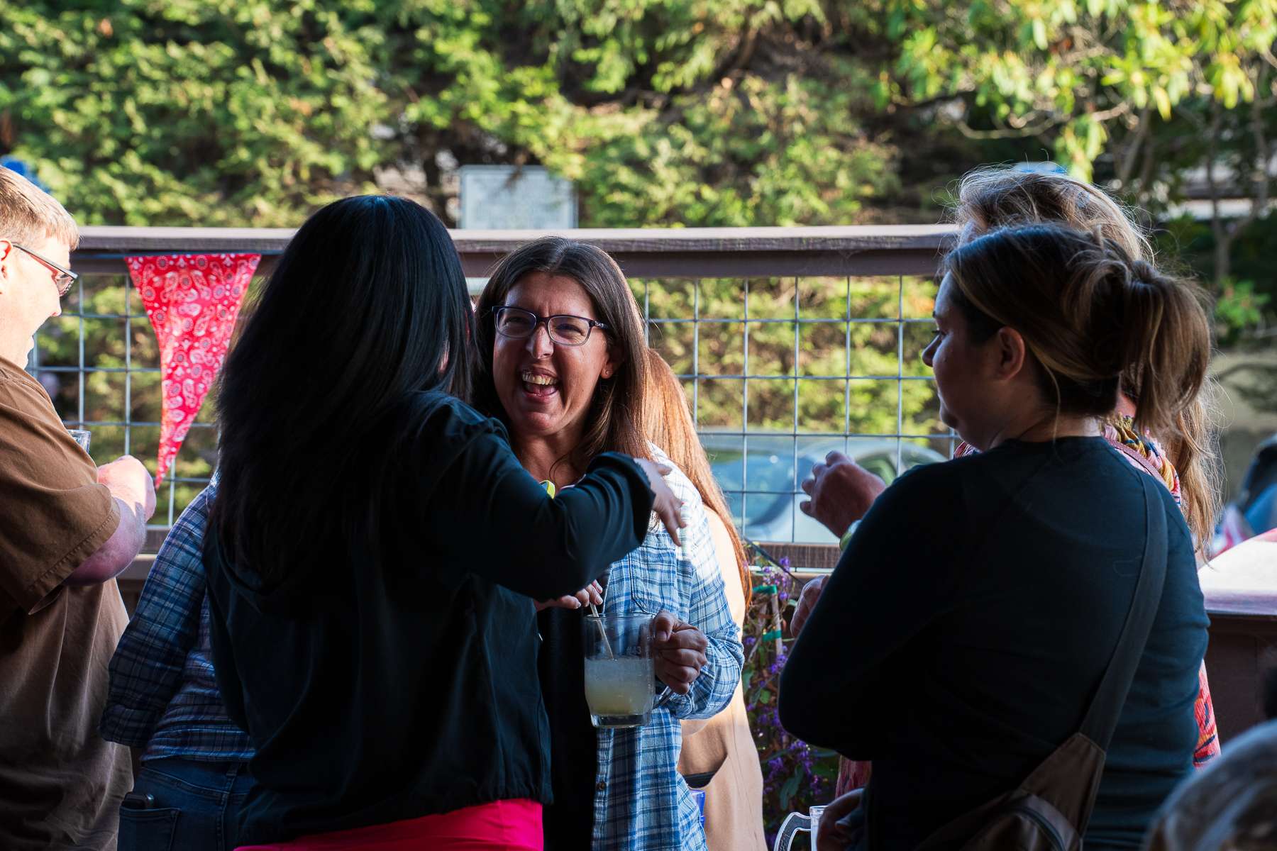 People talking and laughing together at a McKinleyville Chamber community event.
