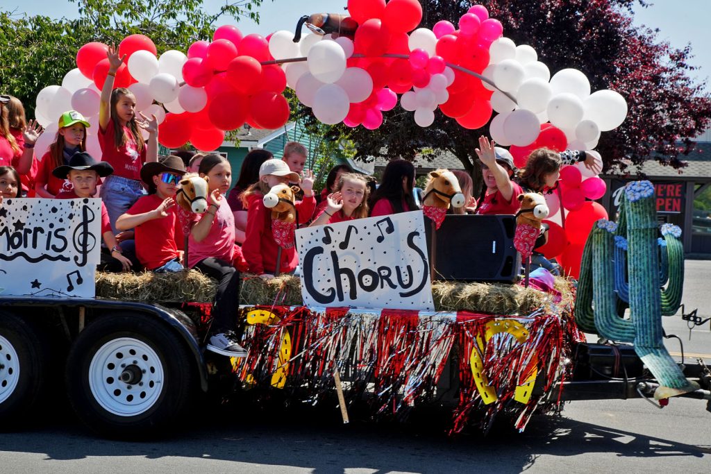 Children riding on a colorful Pony Express Days parade float in McKinleyville, California.