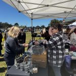 Shopping Local at Pony Express Days 2026 Festival A festival attendee shops at a local vendor booth during the Pony Express Days 2026 Festival in Pierson Park, McKinleyville, California.