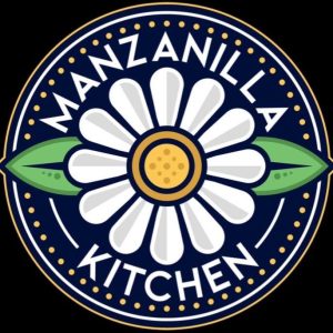 Manzanilla Kitchen circular logo featuring a white and gold chamomile flower with green leaves on a dark blue background