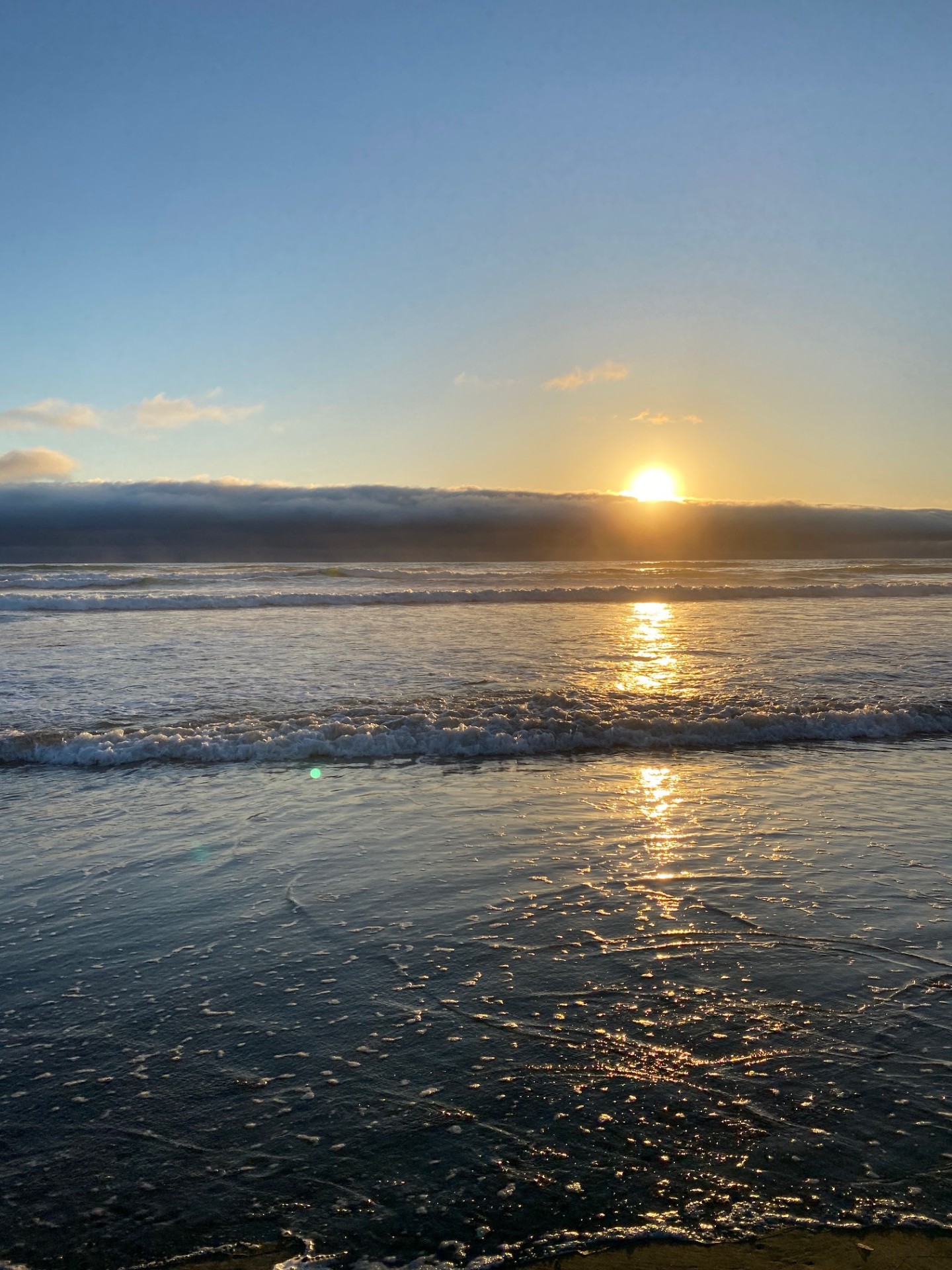 Golden sunset reflecting across the ocean waves at Clam Beach in McKinleyville, California.