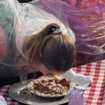 Focused on the Finish A contestant leans into a chocolate cream pie during the Pony Express Days Pie Eating Contest.