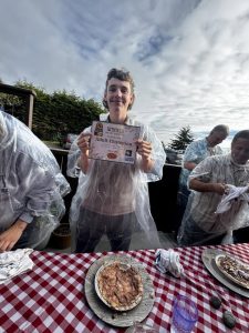 Pony Express Days 2026 Pie Eating Contest Adult Champion Adult Champion winner holds a certificate after the 2026 Pony Express Days Pie Eating Contest at Six Rivers Brewery.