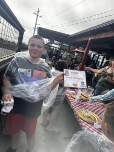 Pony Express Days 2026 Pie Eating Contest Youth Champion Youth Champion winner holds a certificate after the 2026 Pony Express Days Pie Eating Contest at Six Rivers Brewery.