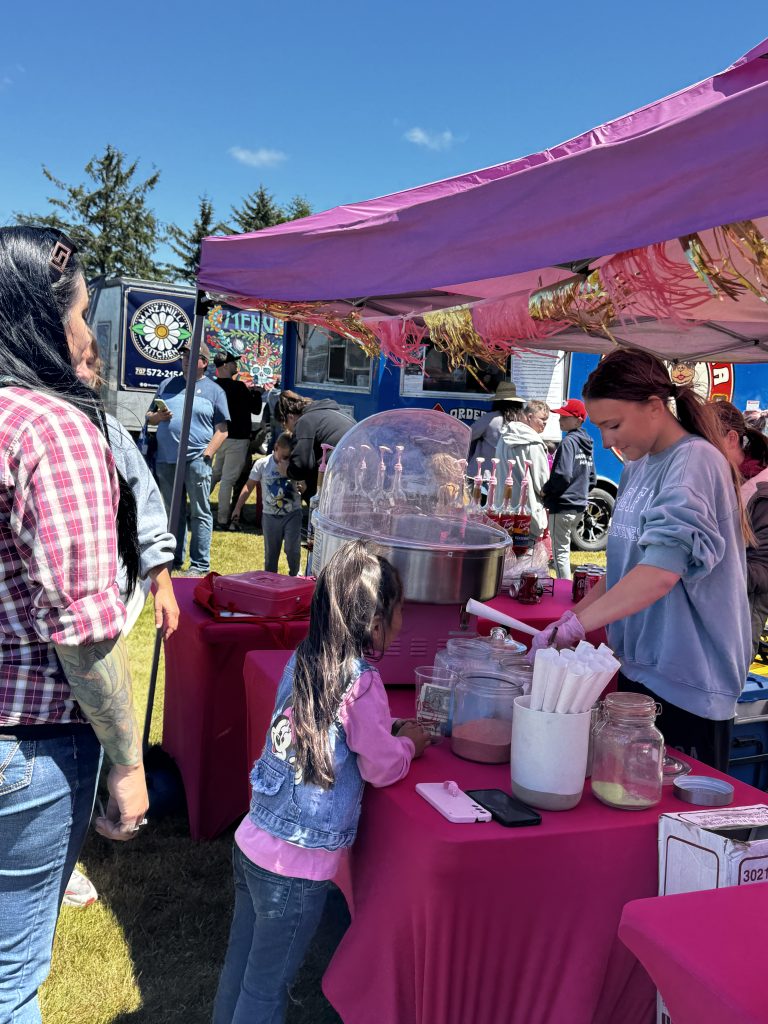 Families visiting vendor booths and food trucks at Pony Express Days in McKinleyville.