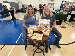 Botanybabe vendors displaying calendula lip balms at the 2025 McKinleyville Chamber Mega Mixer Member Expo