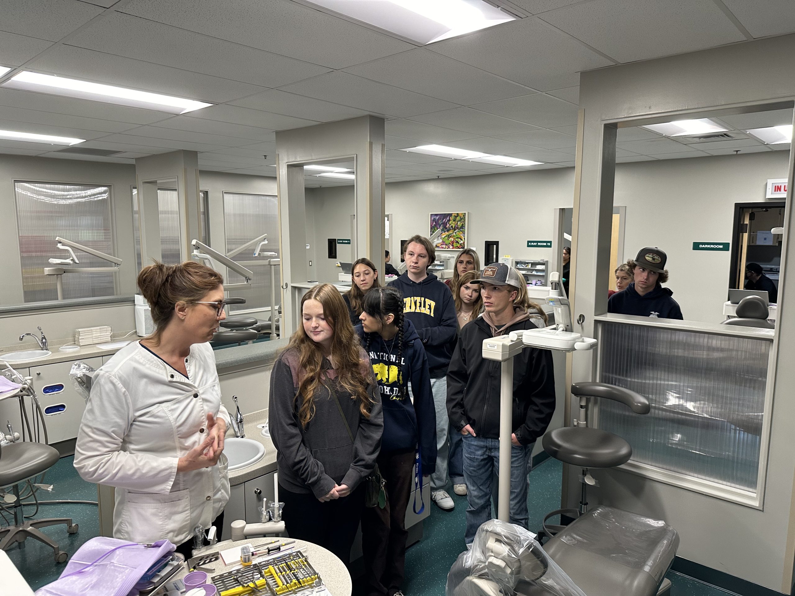 Students exploring career opportunities during a visit to a dental training facility.